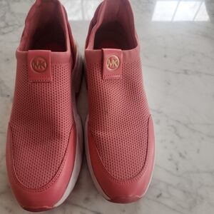 Michael Kors Pink Slip-On Sneakers with gold trim around heel.